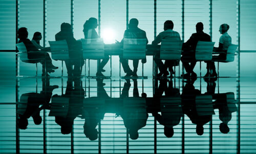 transactional liability insurance. meeting room with silhouettes of people against sun coming in window