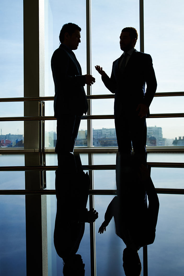 business directors talking in large office